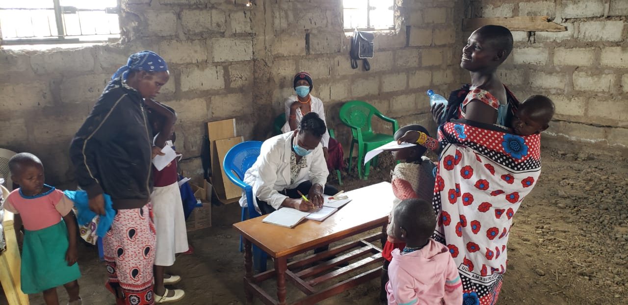 Mothers and children waiting to be seen at an early Entepesi Kenya outreach