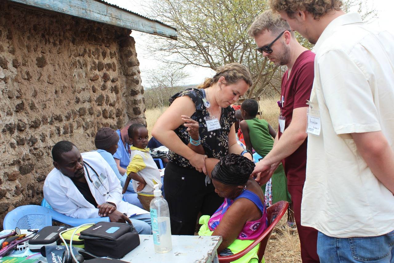 Visiting clinicians examine a patient at a rural medical outreach