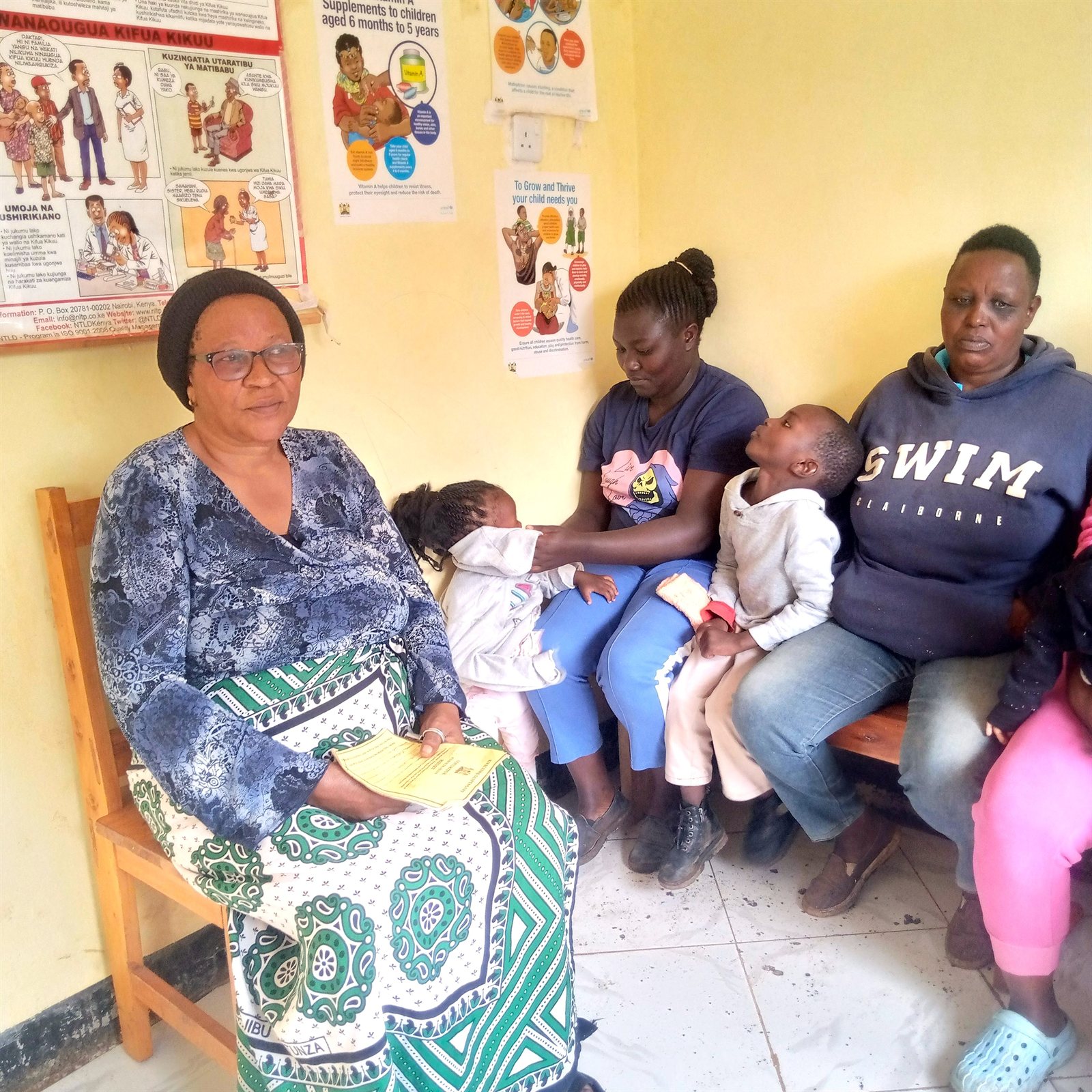 A nurse with mothers and babies at a local health facility