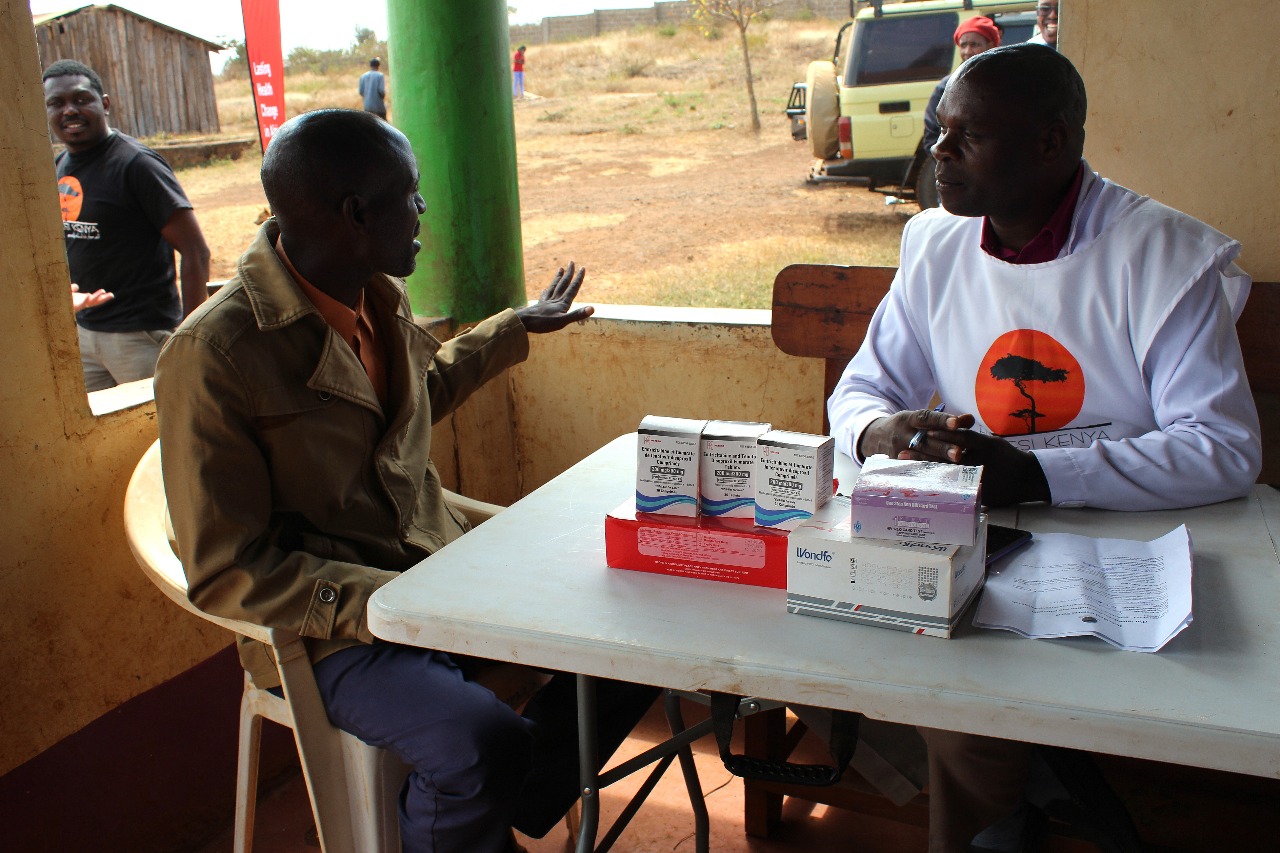 An Entepesi Kenya team member registering a patient at the free medical outreach in Olkaria, Ngama