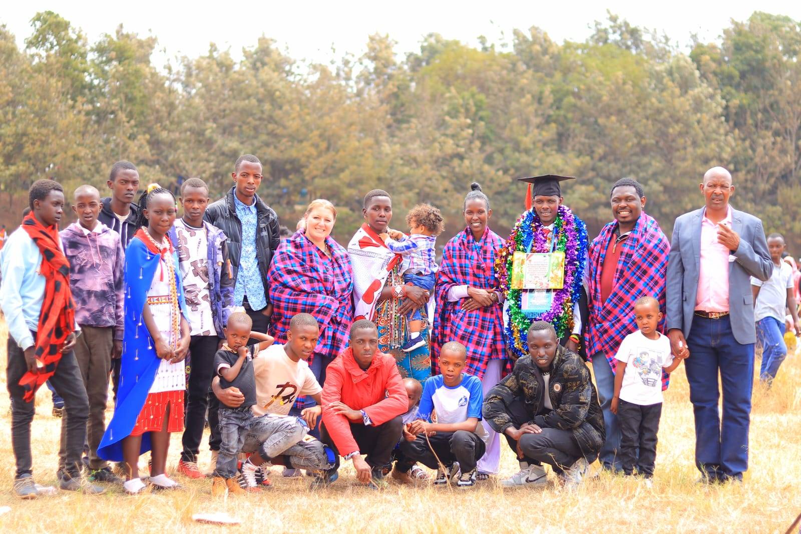 An Entepesi Kenya scholarship graduate celebrates with family and community members