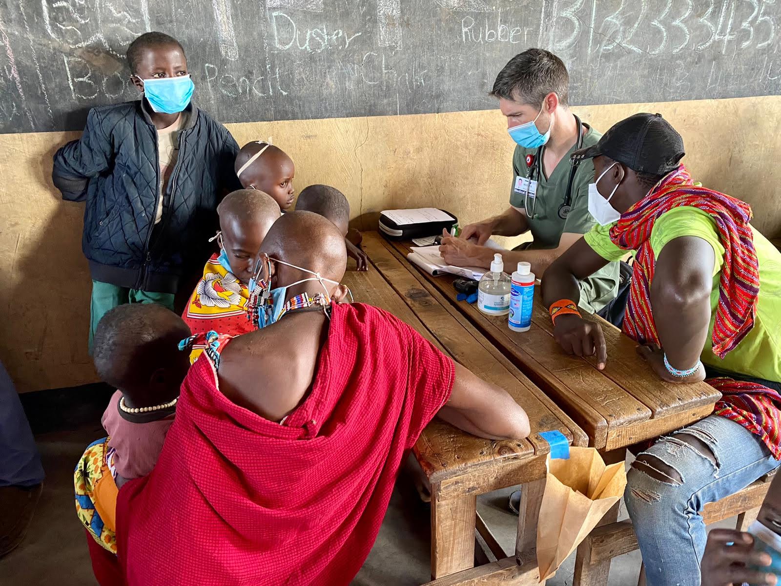 Clinicians consulting patients at a village outreach